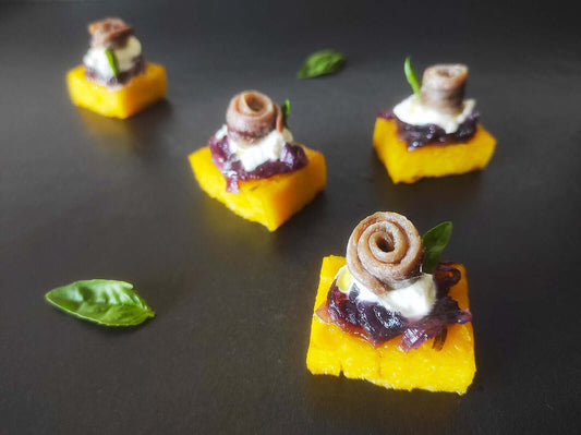 Crostini di polenta con alici cantabriche, stracciatella e cipolle caramellate